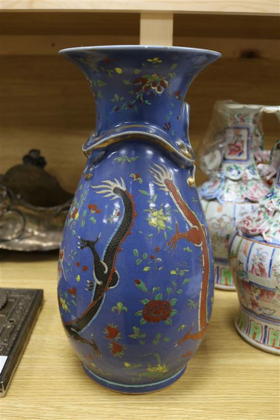 A 19th century Chinese blue ground dragon vase and a pair of famille rose vases tallest 36cm